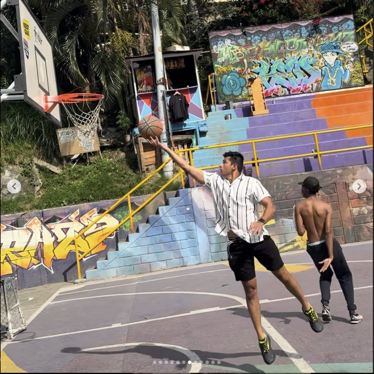 Sameer playing basketball on a Medellín street court